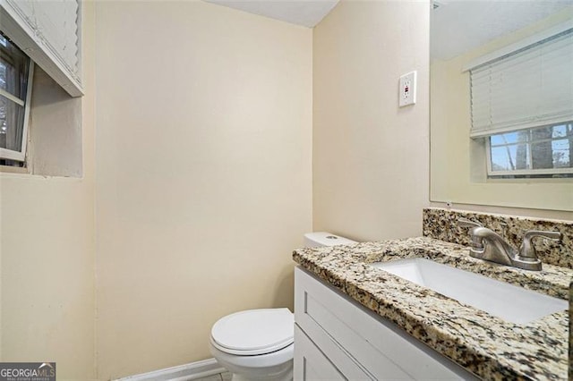 bathroom featuring vanity and toilet