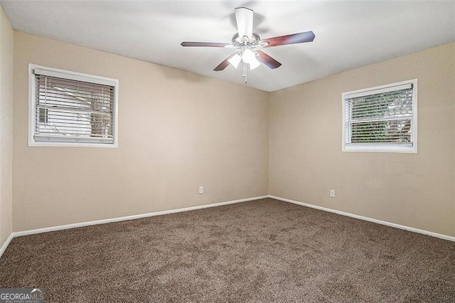 carpeted empty room featuring ceiling fan