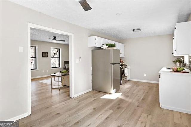 kitchen featuring white cabinetry, sink, ceiling fan, and appliances with stainless steel finishes