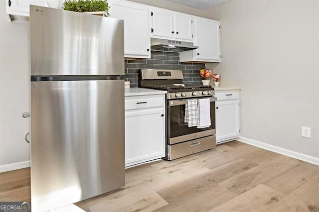 kitchen featuring stainless steel appliances, white cabinetry, tasteful backsplash, and light hardwood / wood-style floors