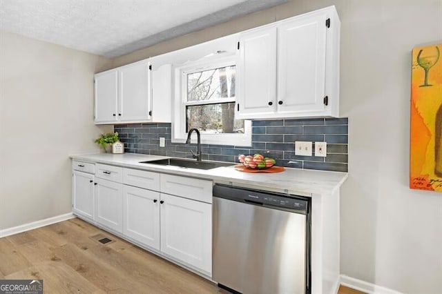 kitchen with sink, decorative backsplash, stainless steel dishwasher, and white cabinets