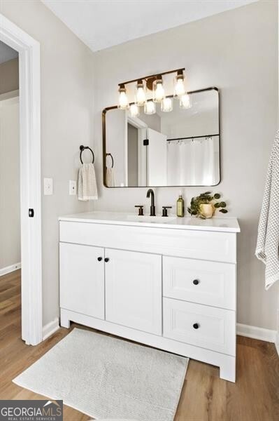 bathroom with vanity and hardwood / wood-style floors