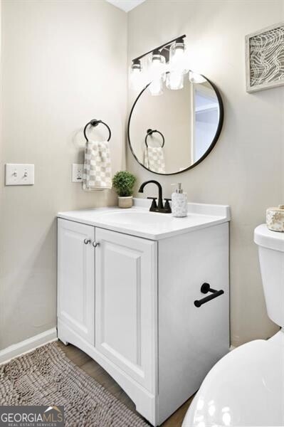 bathroom featuring vanity and toilet