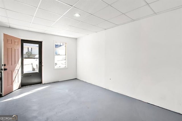 spare room with a drop ceiling and concrete flooring