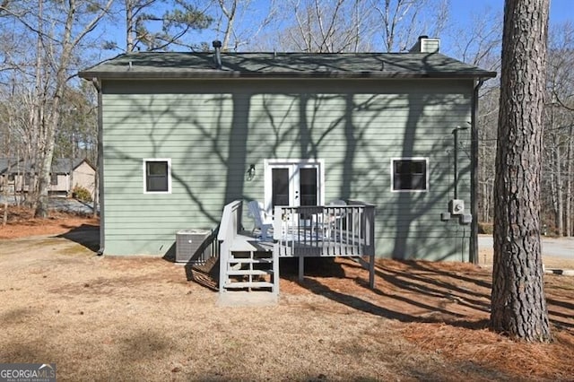 back of house featuring central AC unit, a deck, and french doors