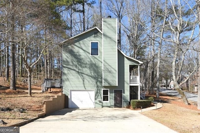 view of side of property with a garage and a balcony