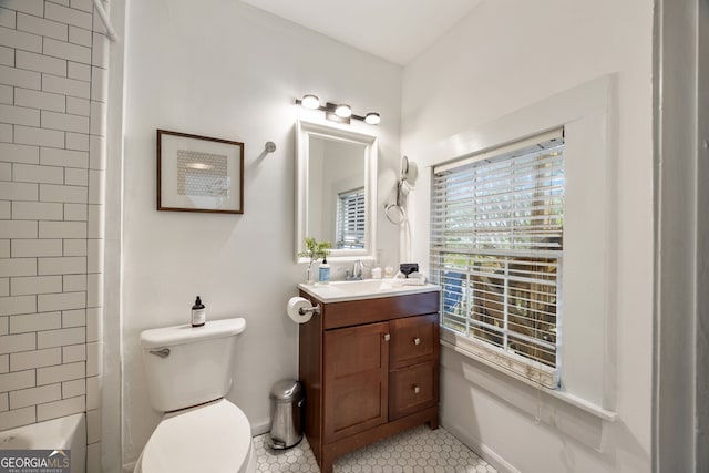 bathroom with vanity, a shower, tile patterned floors, and toilet