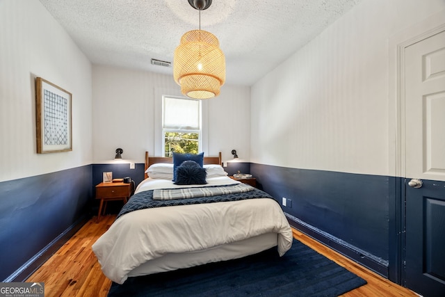 bedroom featuring dark hardwood / wood-style floors and a textured ceiling