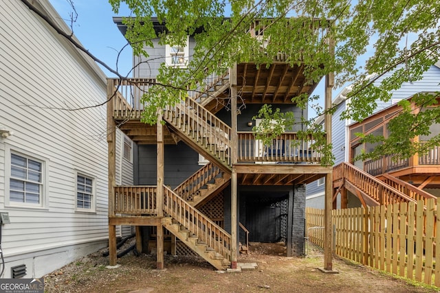 back of house with a wooden deck