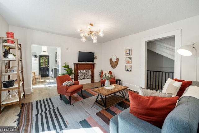 living room featuring light hardwood / wood-style flooring and a notable chandelier