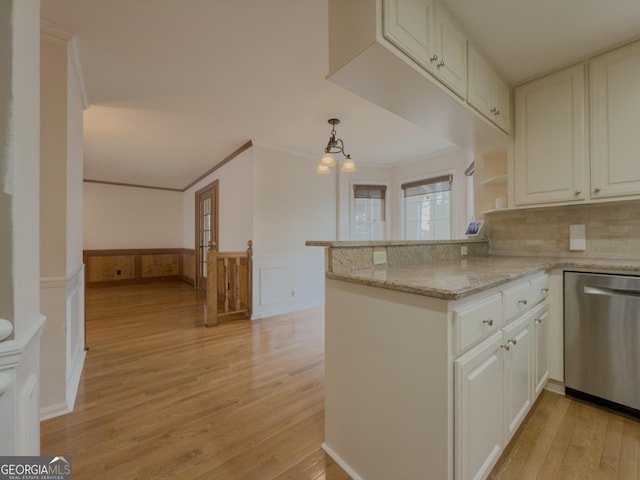 kitchen with white cabinetry, dishwasher, light stone counters, and kitchen peninsula