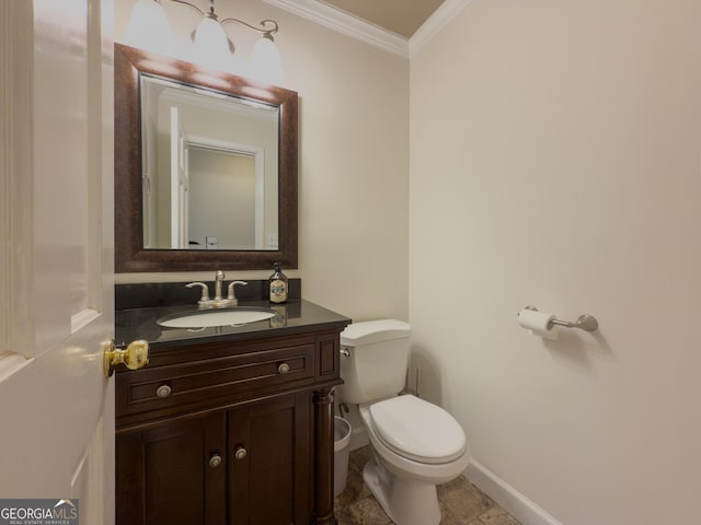 bathroom with crown molding, vanity, and toilet