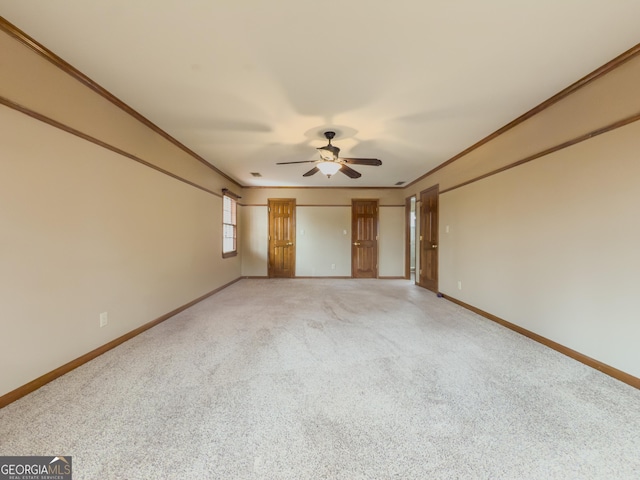 unfurnished bedroom featuring crown molding, ceiling fan, and carpet