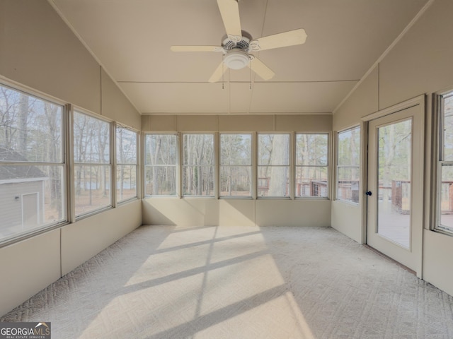 sunroom / solarium featuring ceiling fan, a healthy amount of sunlight, and lofted ceiling