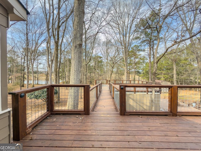 wooden terrace featuring a water view