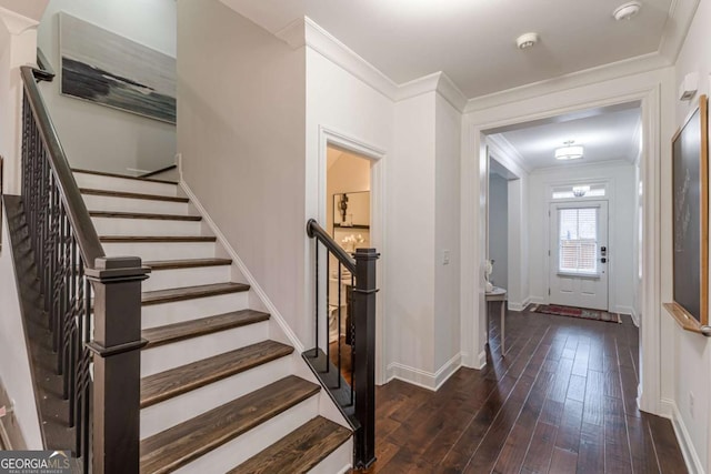 entrance foyer featuring crown molding and dark hardwood / wood-style flooring