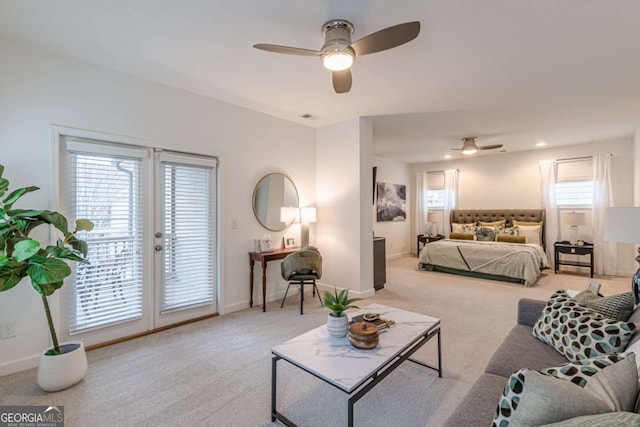 carpeted bedroom featuring french doors, ceiling fan, and access to exterior