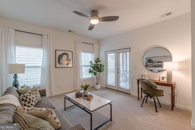 living room with light colored carpet and ceiling fan