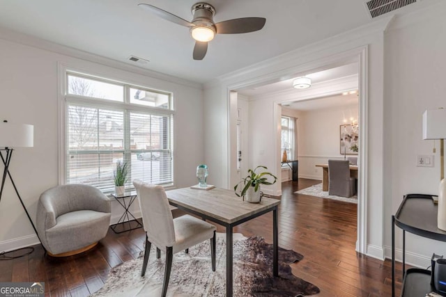 office area with ceiling fan with notable chandelier, dark wood-type flooring, and ornamental molding