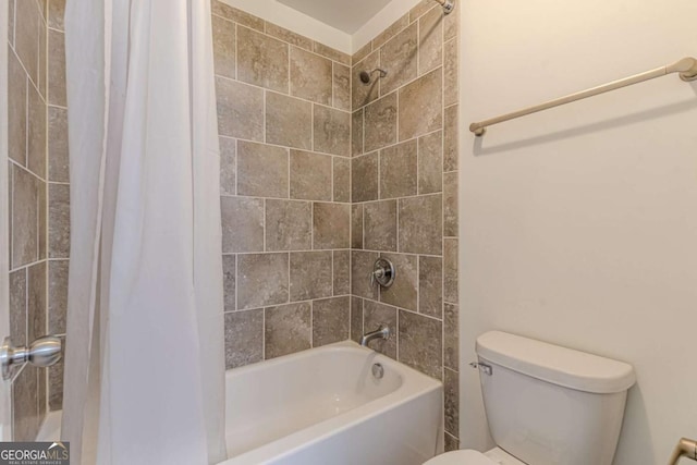 bathroom with shower / tub combo with curtain and toilet