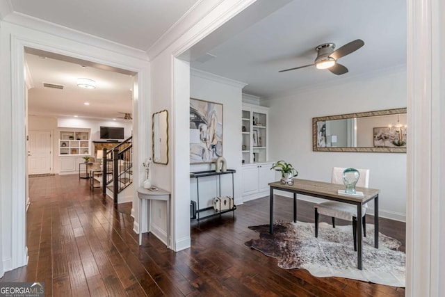 office featuring built in shelves, ornamental molding, dark hardwood / wood-style floors, and ceiling fan