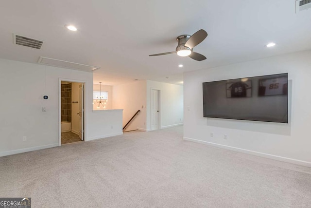 spare room featuring light colored carpet and ceiling fan