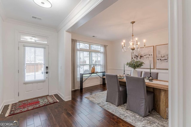 dining space with ornamental molding, a wealth of natural light, and dark hardwood / wood-style flooring