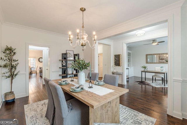 dining room with ornamental molding, dark hardwood / wood-style flooring, and ceiling fan with notable chandelier