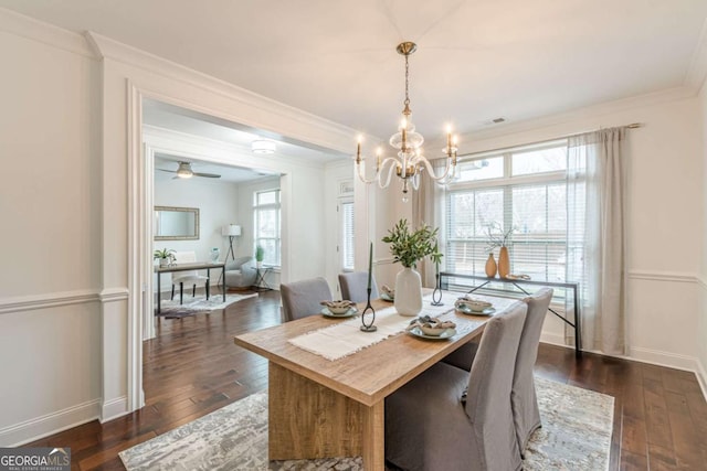 dining room with an inviting chandelier, crown molding, and dark wood-type flooring