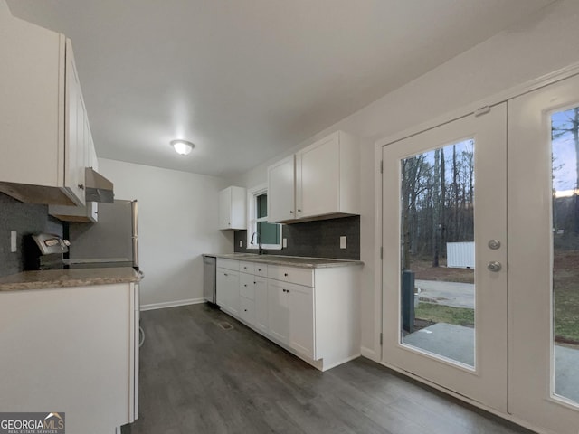 kitchen with sink, dishwasher, white cabinetry, tasteful backsplash, and french doors