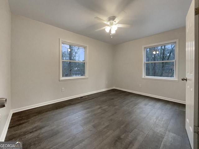 spare room featuring dark hardwood / wood-style floors and ceiling fan