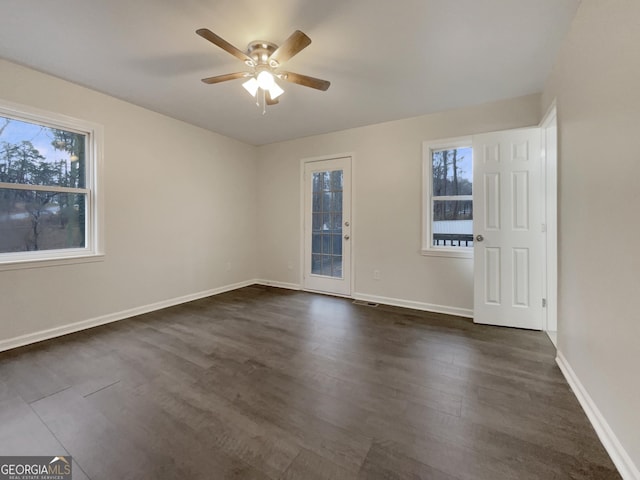 unfurnished room with dark wood-type flooring and ceiling fan