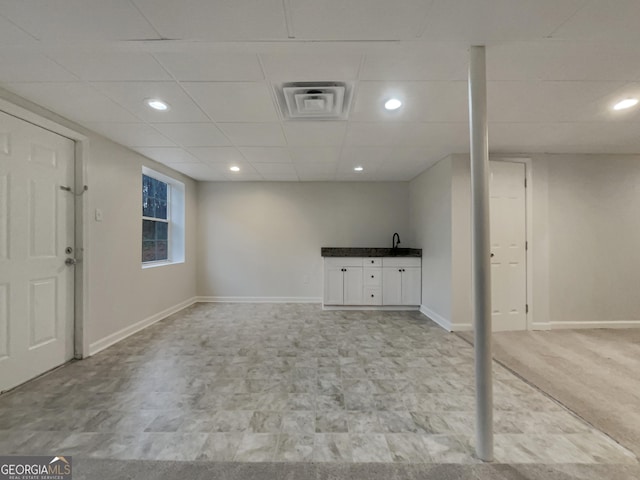 basement with sink and a drop ceiling