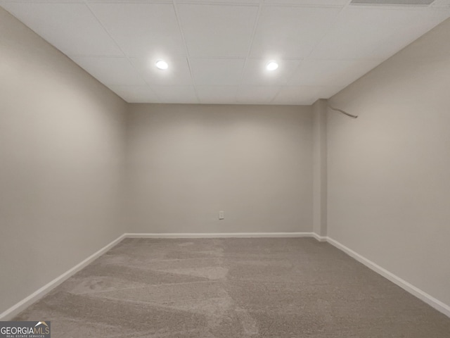 empty room featuring a drop ceiling and carpet floors