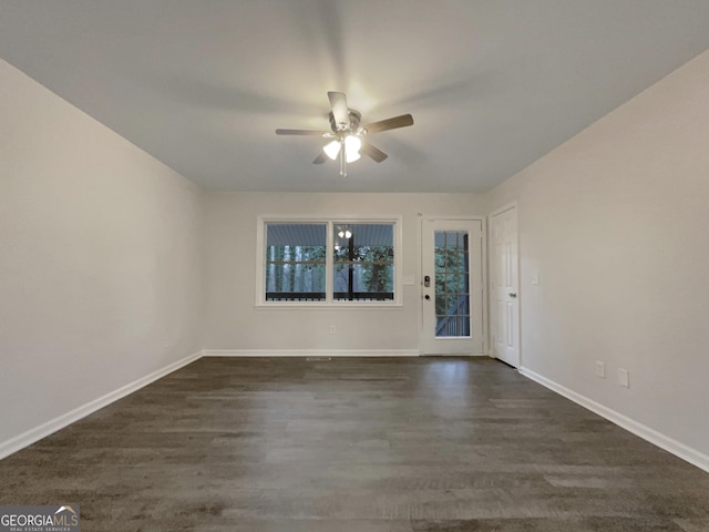 empty room with dark wood-type flooring and ceiling fan