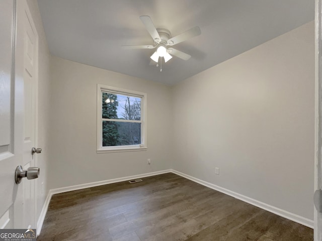 spare room featuring dark hardwood / wood-style floors and ceiling fan