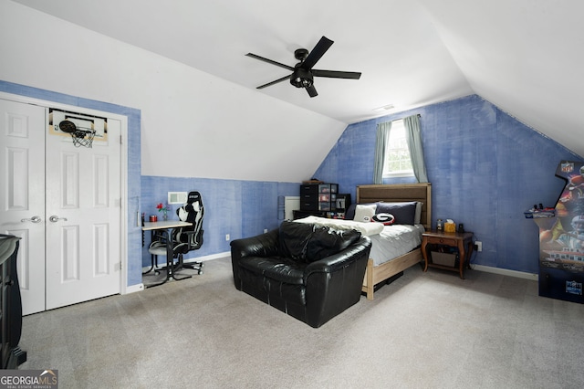 carpeted bedroom with ceiling fan and vaulted ceiling