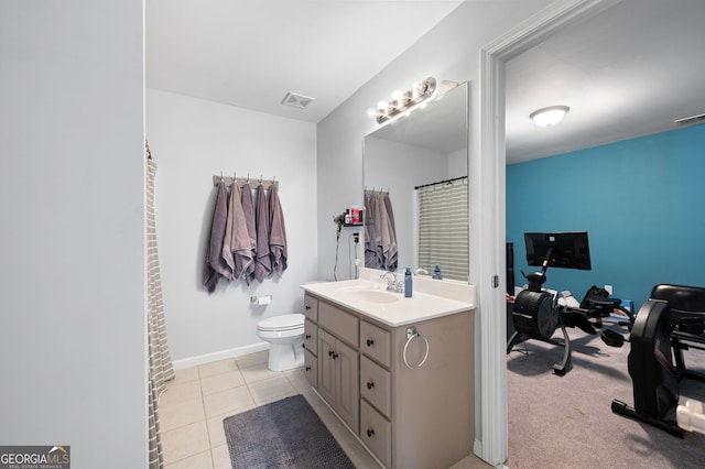 bathroom featuring tile patterned flooring, vanity, and toilet