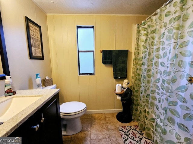 bathroom featuring vanity, a textured ceiling, and toilet