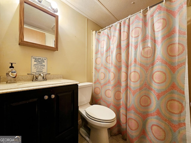 bathroom featuring vanity, tile patterned flooring, and toilet