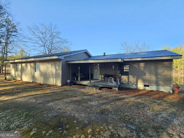 rear view of house with a wooden deck