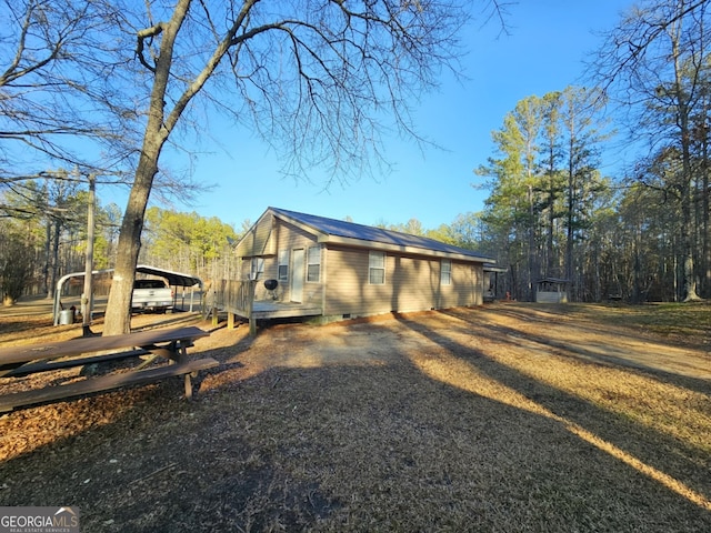 view of property exterior with a carport