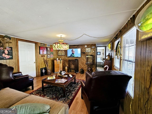 living room with wood-type flooring and wooden walls