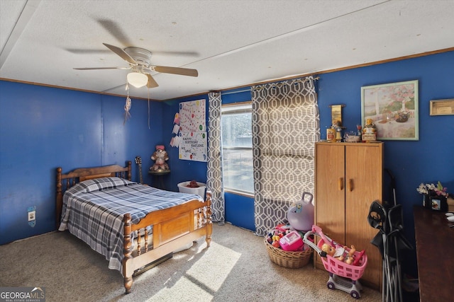 carpeted bedroom with a textured ceiling and ceiling fan