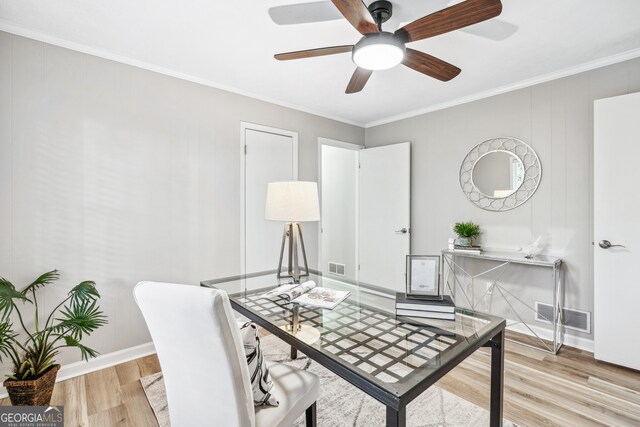 office area featuring ornamental molding, ceiling fan, and light wood-type flooring