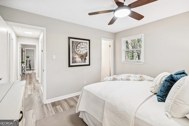 bedroom featuring light hardwood / wood-style floors and ceiling fan