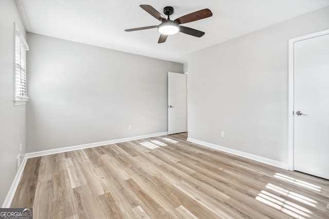 empty room featuring ceiling fan and light wood-type flooring