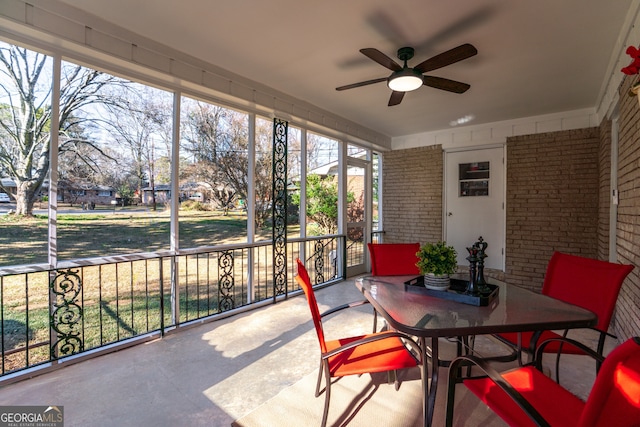 sunroom featuring ceiling fan and a wealth of natural light