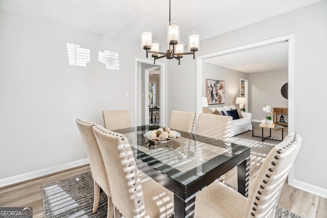 dining room featuring a chandelier and light wood-type flooring