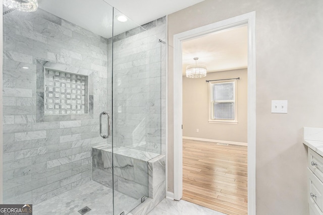 bathroom featuring vanity and a shower with shower door